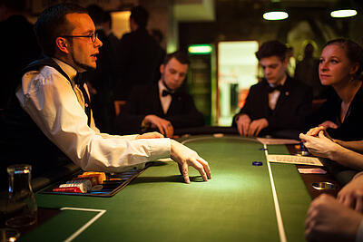 Dealer explaining rules of the game at the poker table.