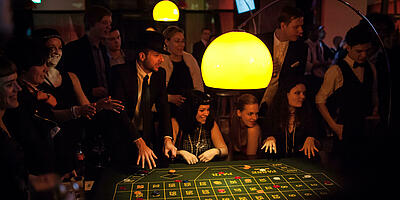 The guests wait eagerly for the picked number in roulette.