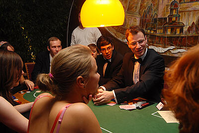 Dealer explains the rules of the game at the poker table. Dealer explains the rules of the game at the poker table to the guests.