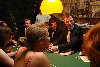 Dealer explains the rules of the game at the poker table. Dealer explains the rules of the game at the poker table to the guests.