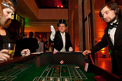 Man in top hat at craps dice table Man in top hat throws the dice at the craps table at a 20s event