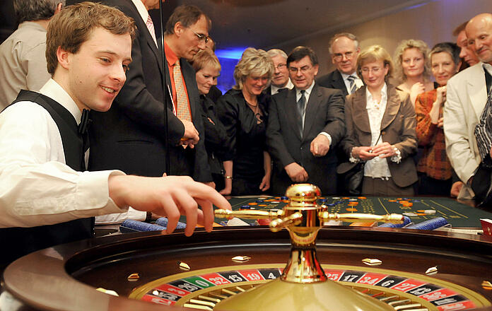 Croupier turns the roulette wheel and the guests are eagerly waiting for the number.