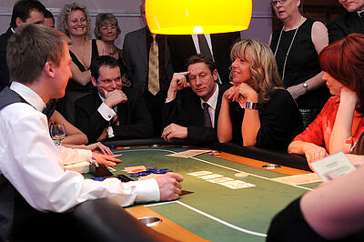 Poker as an idea for the company summer party Guests at a company summer party play poker.