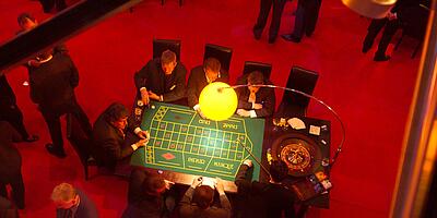 Employees play roulette at a department party