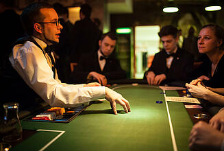 Dealer explains poker rules to guests Dealer explaining rules of the game at the poker table.
