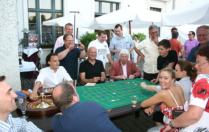 Guests play roulette extensively at a summer party. 