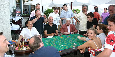 Guests play roulette extensively at a summer party. 