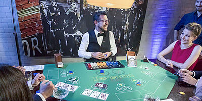 Chef de Partie laughs at the baccarat table