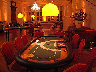 ready-to-use small poker table at an event Ready-to-use small poker table with seating at an event
