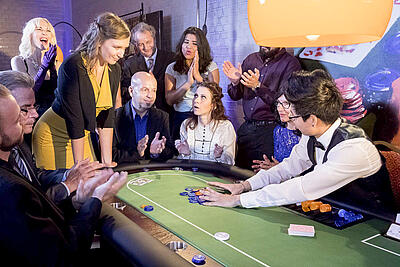 Winning at the poker table Dealer pushes the win to the pot at the poker table.