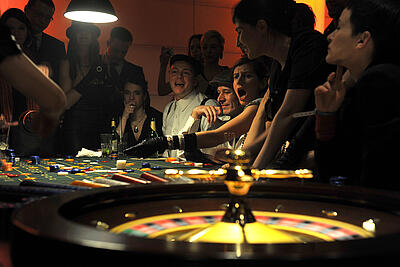 Guests at a theme event enthusiastically play roulette.