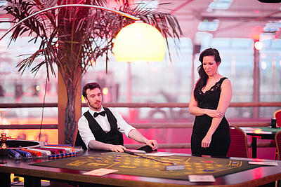 Two croupiers at the big roulette table
