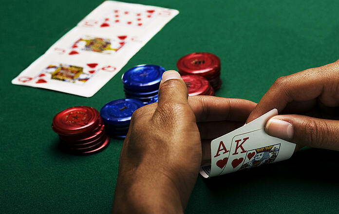 Player's hand shows a royal flush of hearts