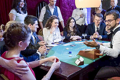 Croupier calls on the first player at baccarat.